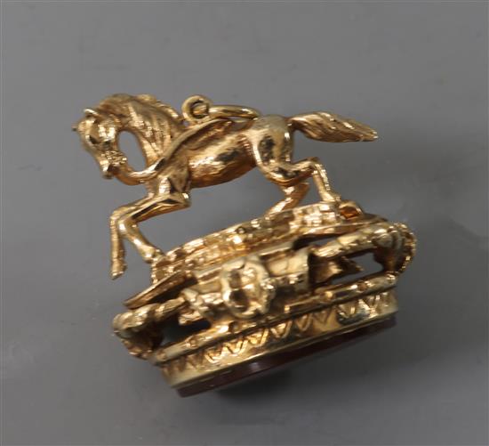 A 9ct gold and carnelian fob surmounted with a horse, 26mm.
